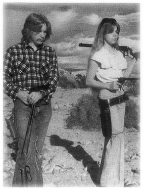 [Teenagers Arthur and Doreen with rifles]